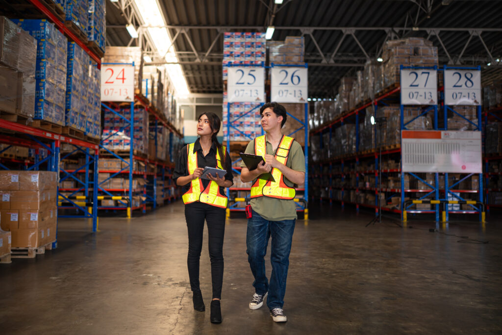warehouse manager talking and checking product in warehouse.